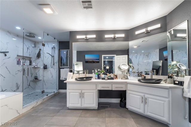 bathroom with walk in shower, vanity, and a textured ceiling