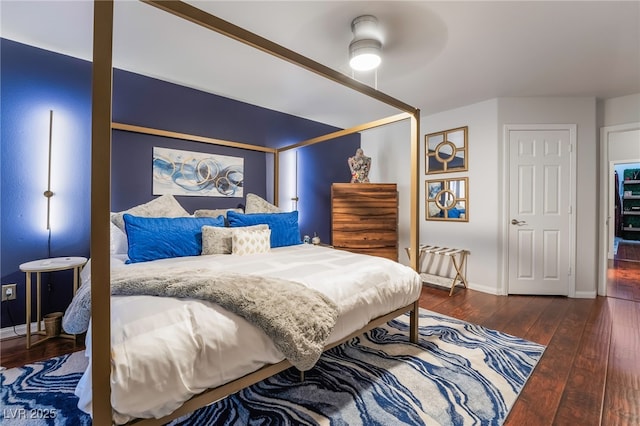 bedroom featuring ceiling fan and dark hardwood / wood-style floors