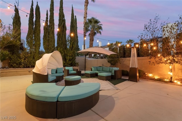 patio terrace at dusk featuring an outdoor hangout area