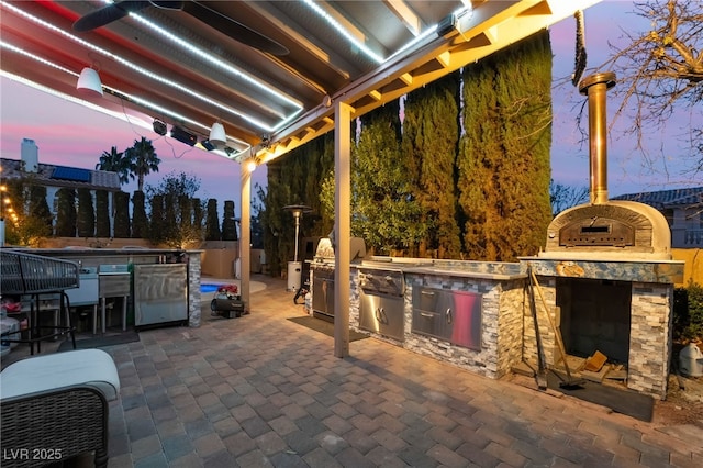 patio terrace at dusk with area for grilling