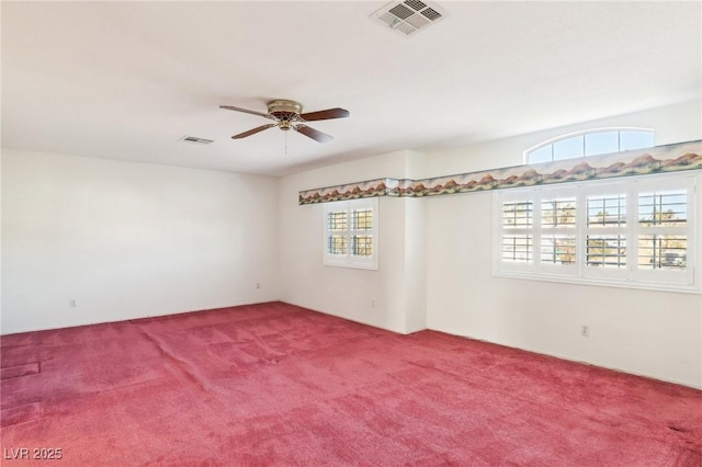 carpeted spare room featuring ceiling fan