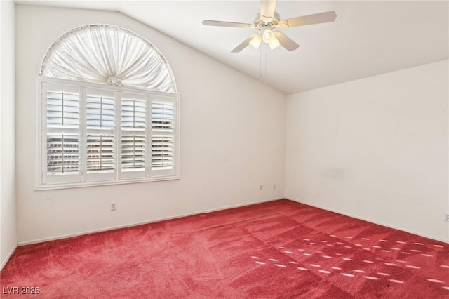 carpeted spare room featuring vaulted ceiling and ceiling fan