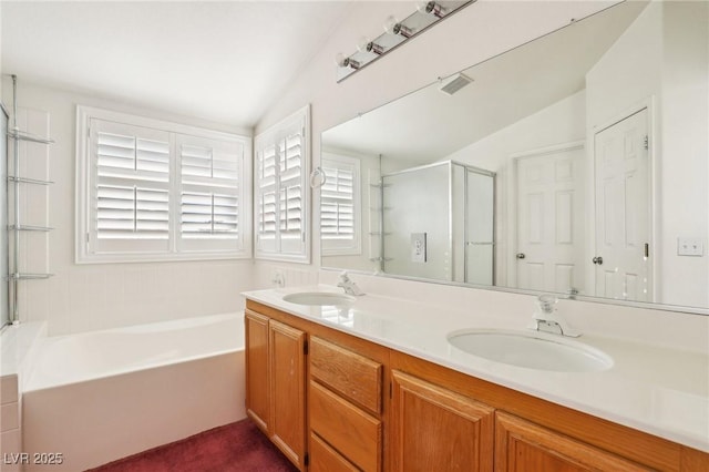 bathroom with vanity, vaulted ceiling, and plus walk in shower