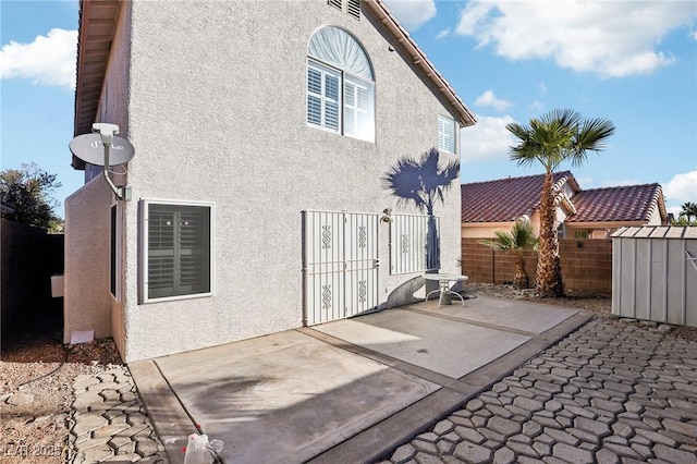 rear view of property featuring a patio