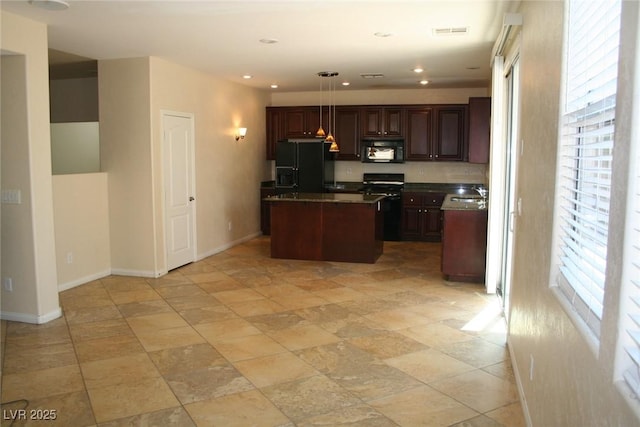 kitchen with pendant lighting, dark brown cabinetry, black appliances, a kitchen island, and sink