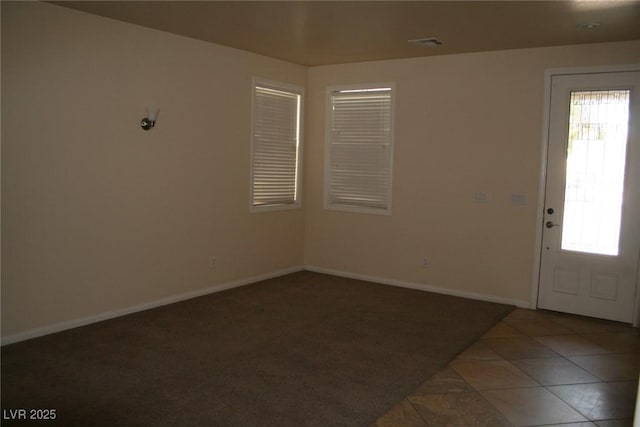 entrance foyer with dark tile patterned floors