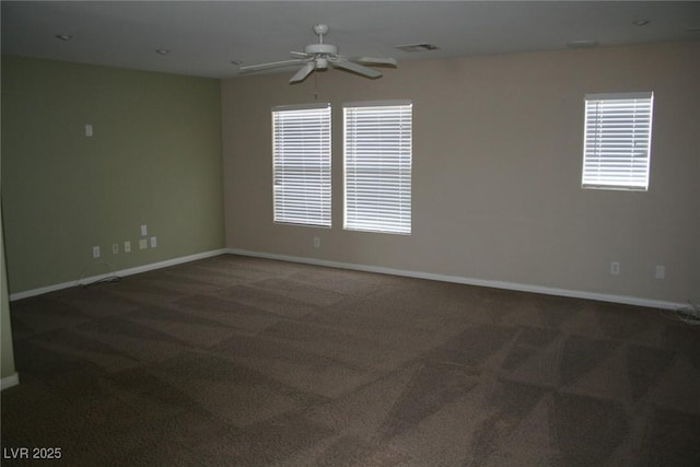 unfurnished room with ceiling fan and dark carpet