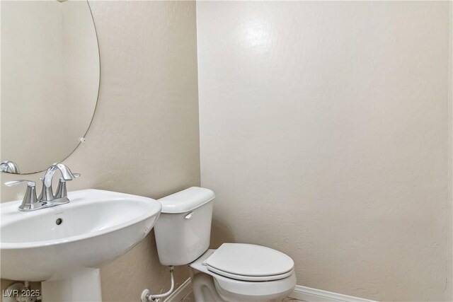 bathroom featuring toilet and sink