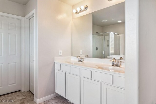 bathroom featuring walk in shower and vanity