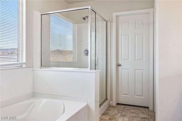 bathroom with shower with separate bathtub