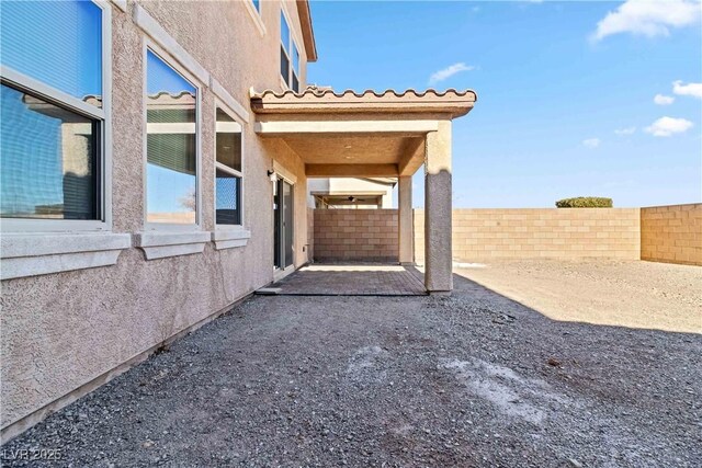 view of side of property with a patio