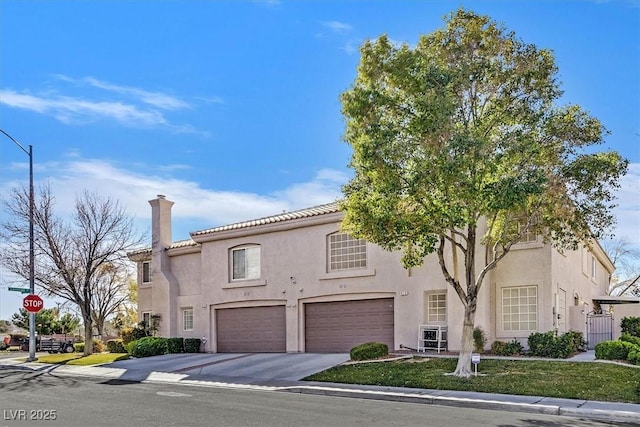 mediterranean / spanish-style house with a garage