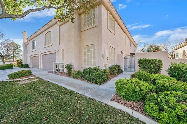 view of side of home featuring a garage and a yard