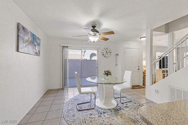 dining space with ceiling fan and light tile patterned floors