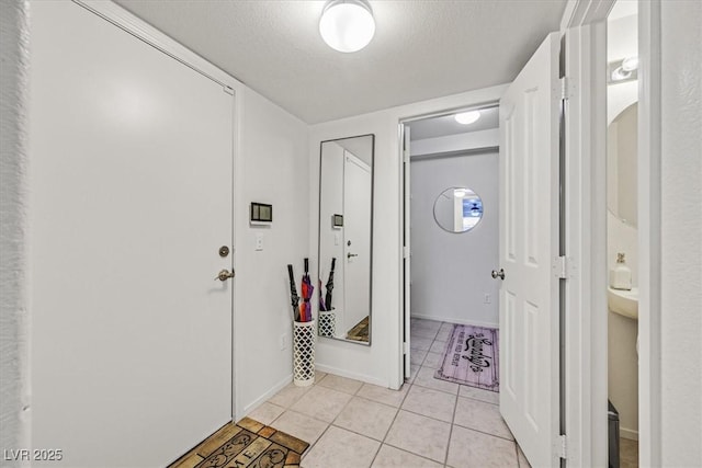 tiled foyer entrance with a textured ceiling