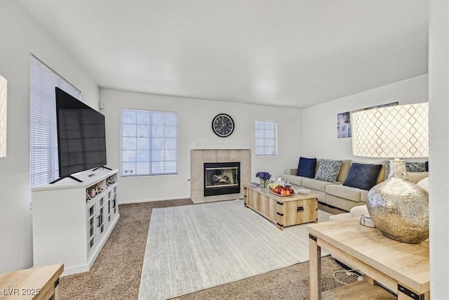 living room featuring carpet floors and a tile fireplace