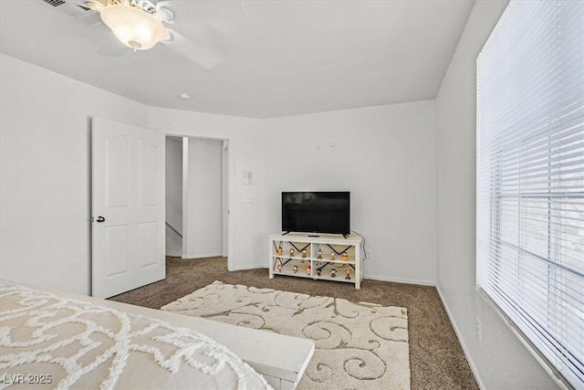 carpeted bedroom featuring ceiling fan and a closet