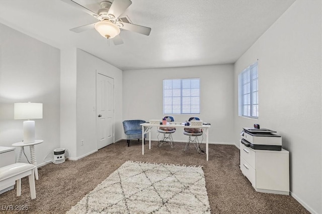 office featuring ceiling fan and dark carpet