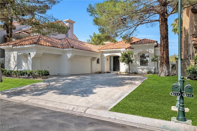 mediterranean / spanish home with a front lawn and a garage