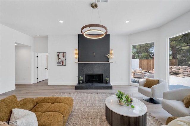 living room with a fireplace and light hardwood / wood-style flooring