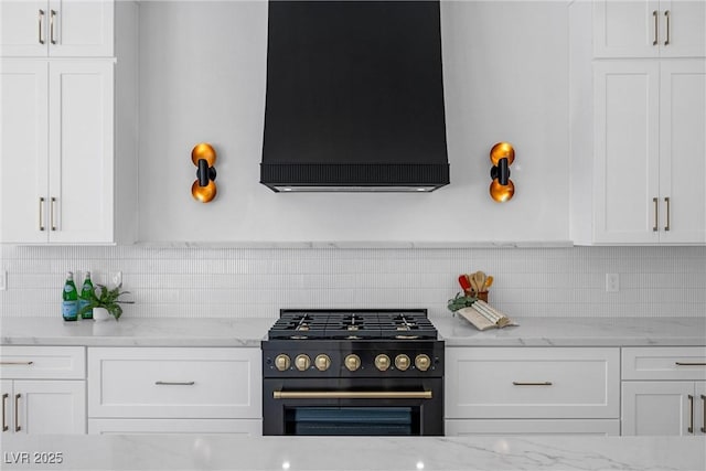 kitchen with range with gas cooktop, white cabinets, and custom range hood