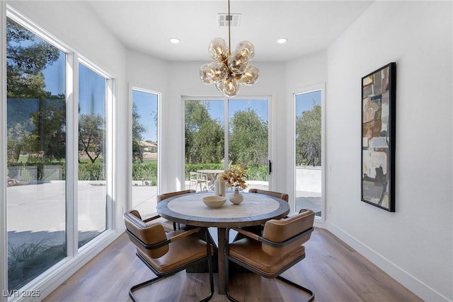 dining room with an inviting chandelier and light hardwood / wood-style floors