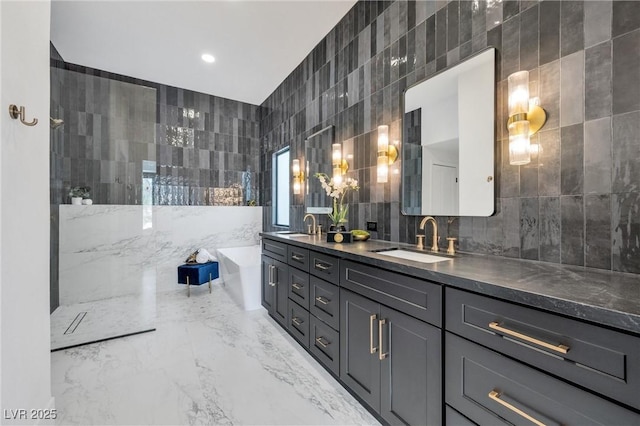 bathroom with tile walls, vanity, and a bath