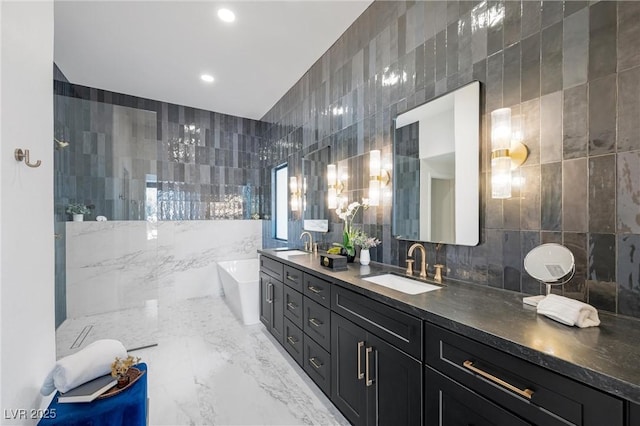 bathroom with a washtub, tile walls, and vanity