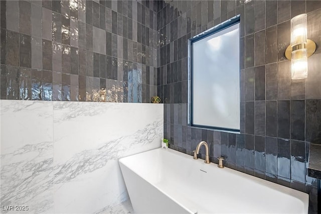 bathroom featuring tile walls and a tub