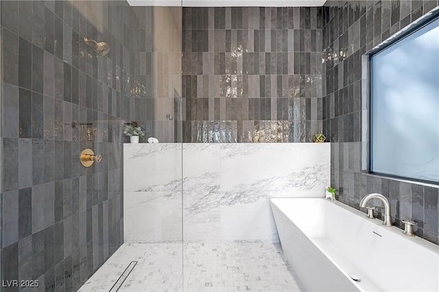 bathroom with shower with separate bathtub, decorative backsplash, and tile walls