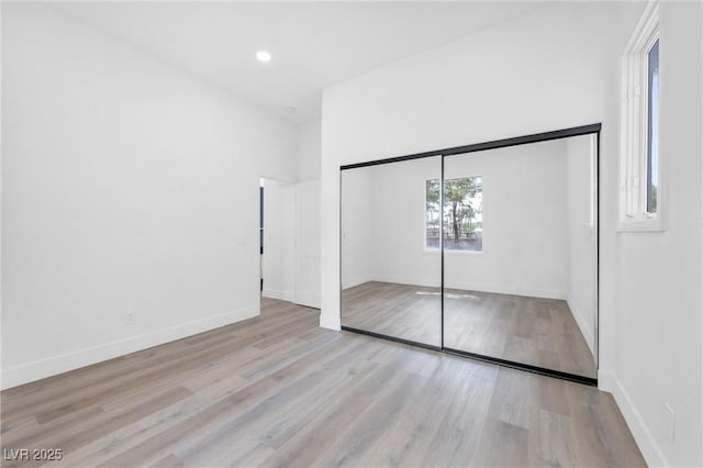 unfurnished bedroom featuring a closet and light hardwood / wood-style flooring