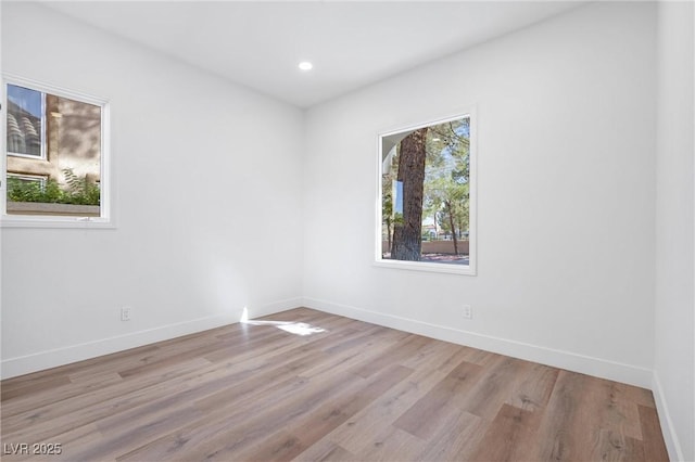 unfurnished room with light wood-type flooring