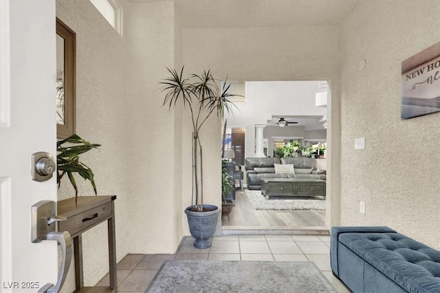 tiled entrance foyer featuring ceiling fan