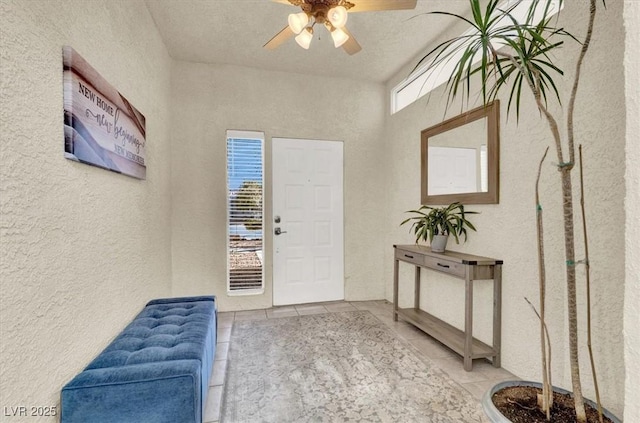 tiled entryway featuring ceiling fan