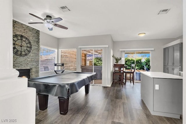 game room with ceiling fan, billiards, dark hardwood / wood-style floors, and a fireplace