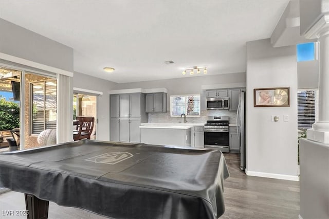 recreation room featuring billiards, dark hardwood / wood-style floors, sink, and a healthy amount of sunlight