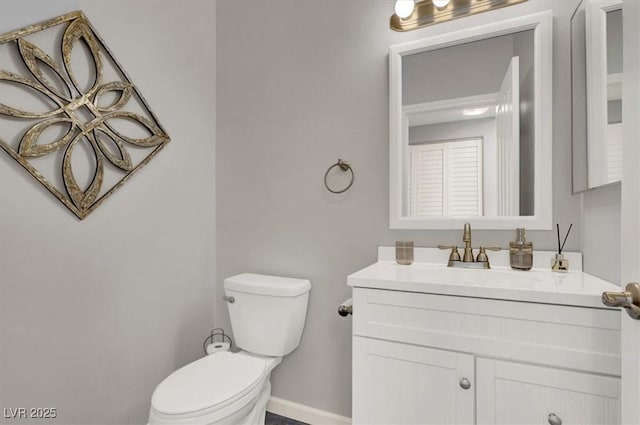 bathroom with toilet and vanity