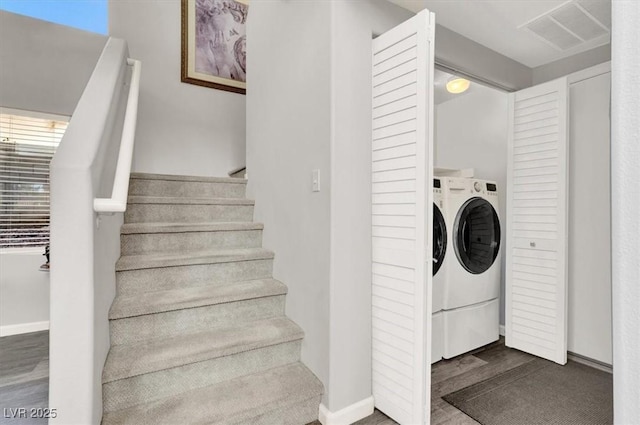 clothes washing area with dark hardwood / wood-style flooring