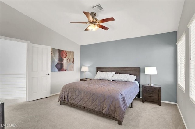 carpeted bedroom with ceiling fan, lofted ceiling, and multiple windows