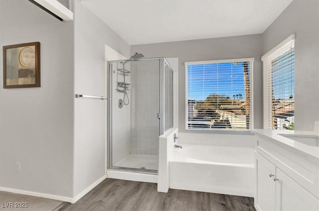 bathroom featuring hardwood / wood-style floors, vanity, and independent shower and bath