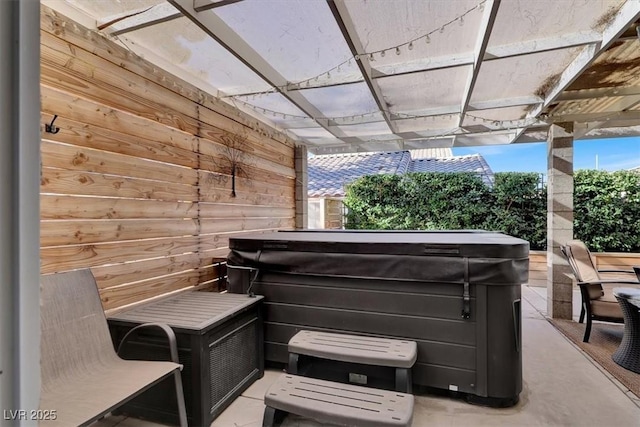 misc room featuring a jacuzzi and wooden walls