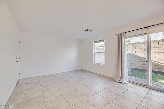 unfurnished room featuring light tile patterned floors