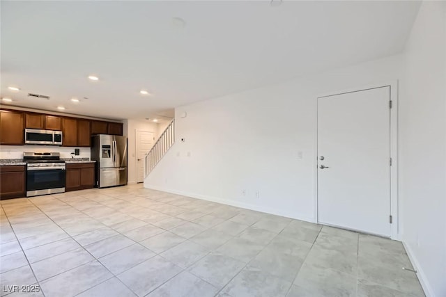 kitchen featuring light tile patterned floors and stainless steel appliances