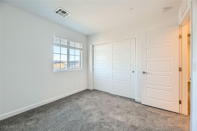 unfurnished bedroom featuring carpet and a closet