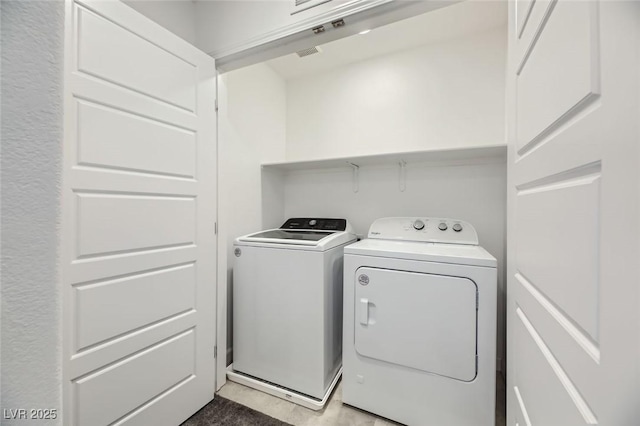 clothes washing area featuring washer and dryer