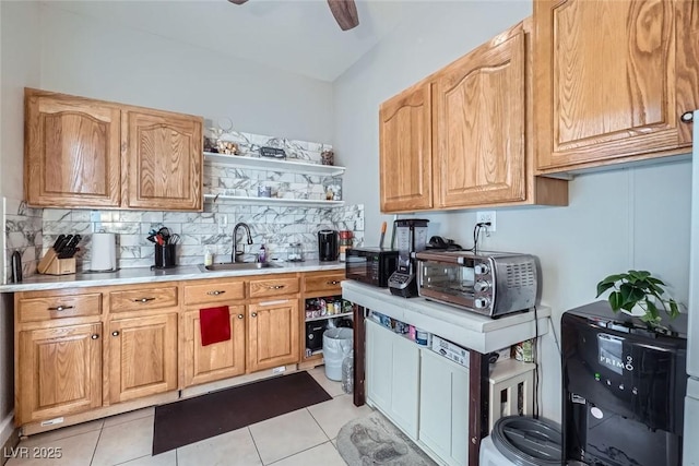 kitchen with ceiling fan, light tile patterned floors, decorative backsplash, and sink