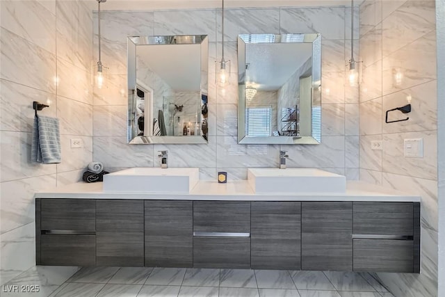 bathroom featuring vanity and tile walls