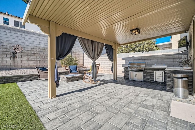 view of patio / terrace featuring an outdoor kitchen, a fire pit, and grilling area