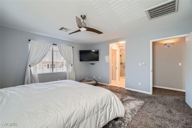 bedroom with ceiling fan, connected bathroom, and dark carpet