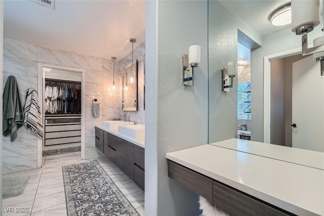 bathroom featuring tile walls and vanity